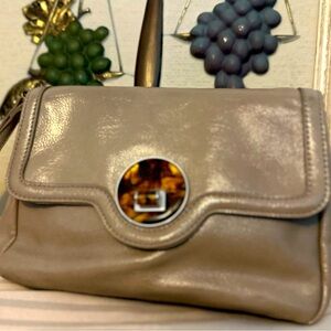 EUC New York and Co taupe wristlet with turn key flap adorned with a faux jewel.